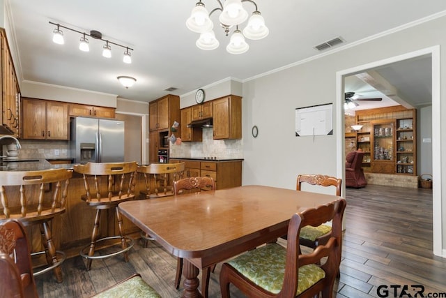 10516 Debbie Ln, Flint, TX 75762 - dining area with dark wood finished floors, a ceiling fan, ornamental molding, and a chandelier