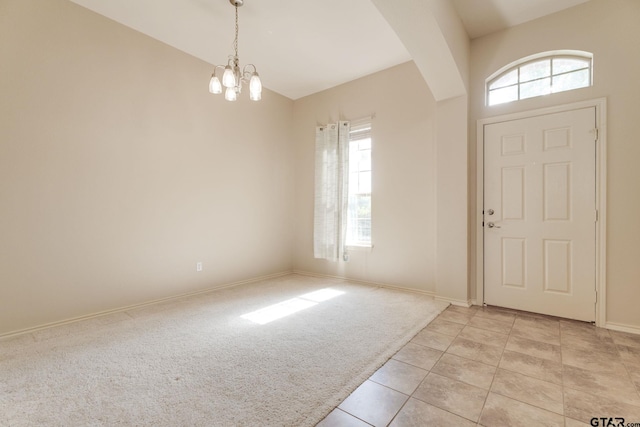 5821 Thompson Pl, Tyler, TX 75707 - foyer entrance with a chandelier, plenty of natural light, light tile patterned floors, and light colored carpet