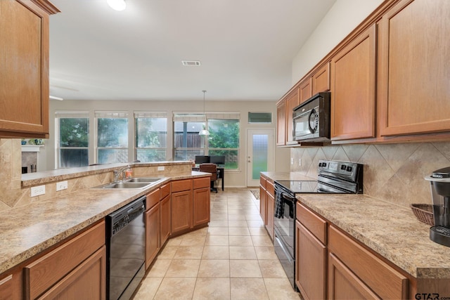 5821 Thompson Pl, Tyler, TX 75707 - kitchen featuring black appliances, tasteful backsplash, light tile patterned floors, brown cabinets, and light countertops