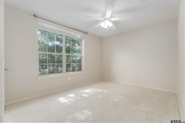 5821 Thompson Pl, Tyler, TX 75707 - carpeted spare room with baseboards and a ceiling fan