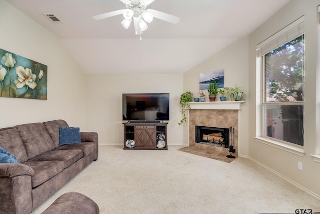 5821 Thompson Pl, Tyler, TX 75707 - carpeted living area featuring lofted ceiling, a tiled fireplace, and a ceiling fan