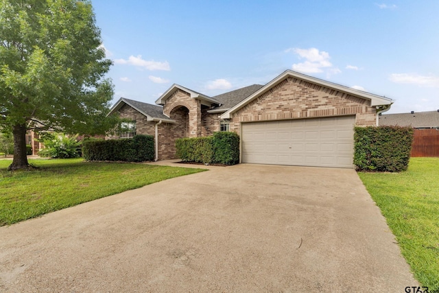 5821 Thompson Pl, Tyler, TX 75707 - view of front of home with brick siding, a garage, driveway, and a shingled roof