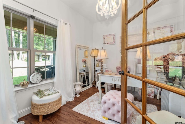 office space featuring a notable chandelier and wood finished floors