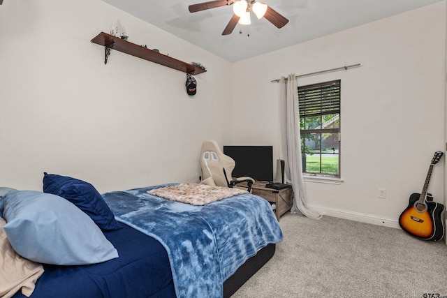 carpeted bedroom with ceiling fan and baseboards