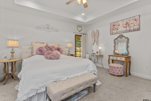 carpeted bedroom with baseboards, a ceiling fan, ornamental molding, a tray ceiling, and recessed lighting