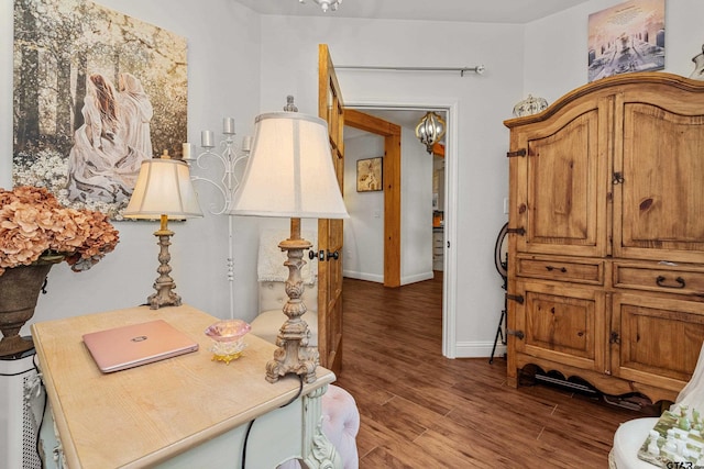 interior space with a notable chandelier, baseboards, and wood finished floors