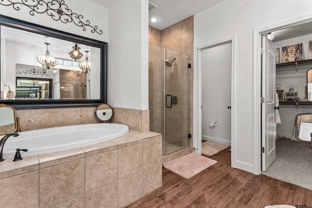 full bathroom with a garden tub, wood finished floors, and a shower stall