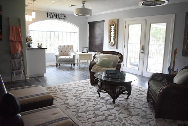 living room with crown molding, french doors, wood finished floors, and visible vents