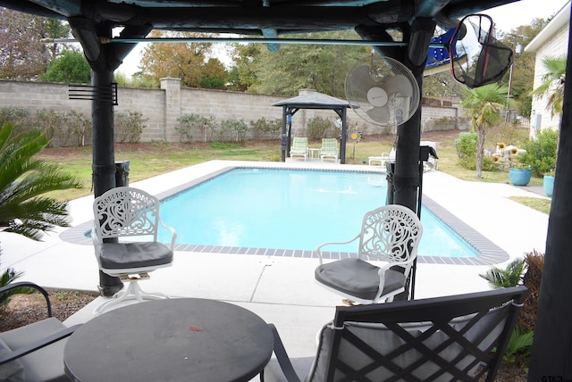 view of pool with a fenced in pool, a patio area, and fence