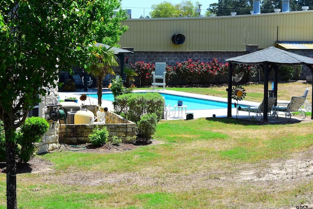 outdoor pool featuring a yard