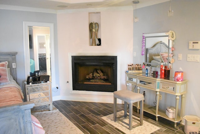 bedroom featuring crown molding, baseboards, dark wood-style floors, and a fireplace