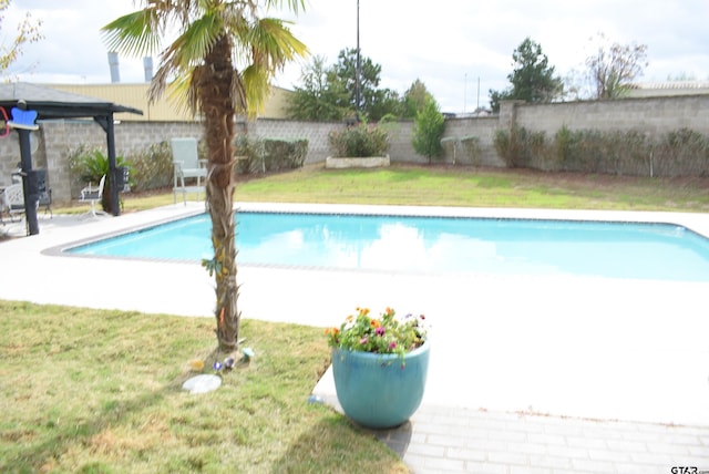 view of pool with a fenced in pool, a fenced backyard, and a lawn