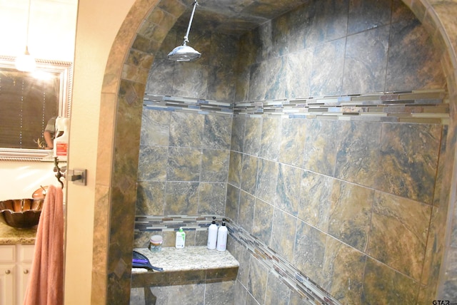 bathroom with a sink and tiled shower