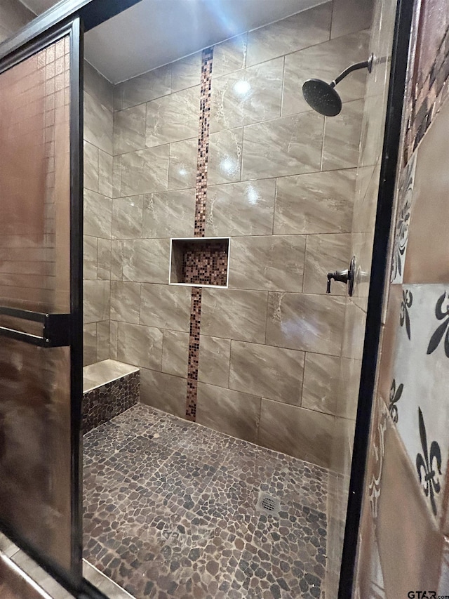 bathroom with tiled shower