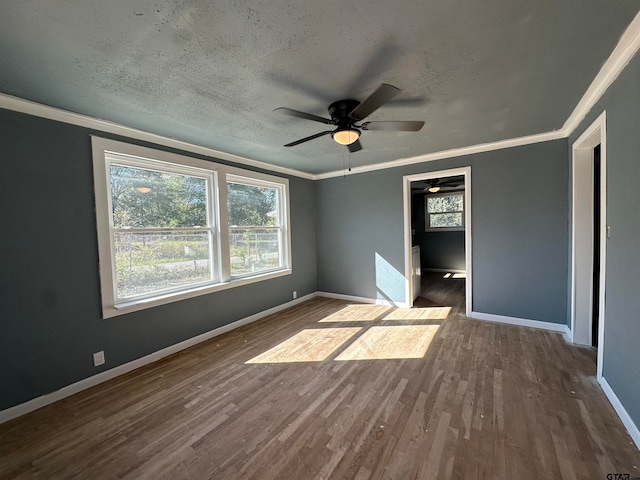 unfurnished bedroom featuring ceiling fan, hardwood / wood-style floors, crown molding, and a textured ceiling