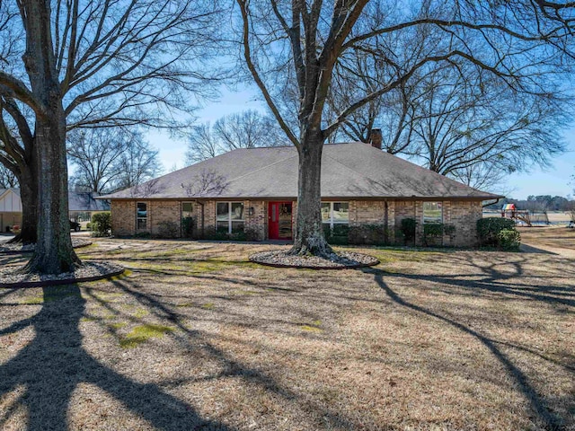 ranch-style house with brick siding and a chimney