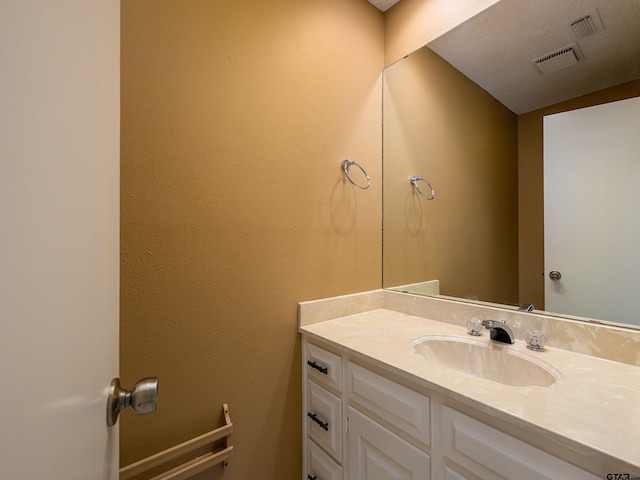 bathroom with visible vents and vanity