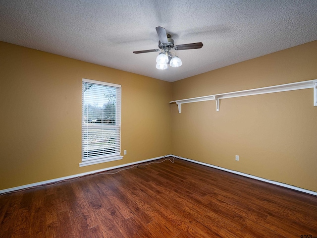 spare room featuring a textured ceiling, a ceiling fan, and wood finished floors