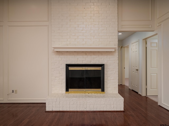 interior details featuring a fireplace and wood finished floors