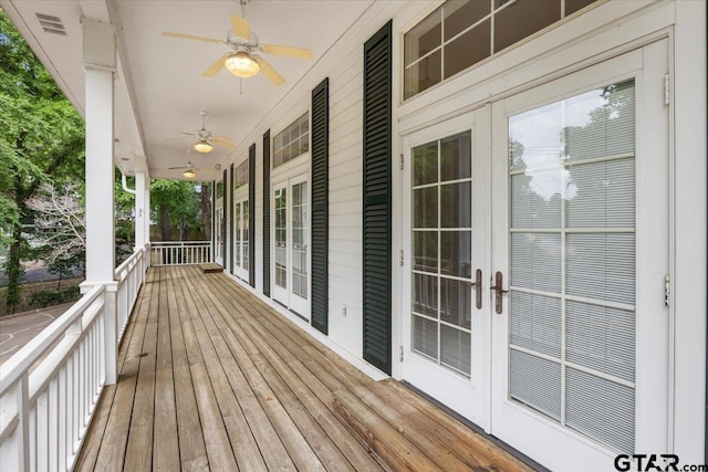 wooden terrace with ceiling fan and french doors