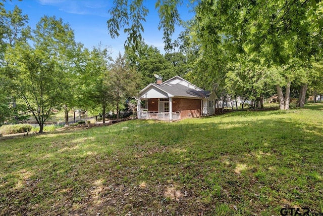 view of yard with covered porch