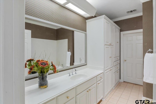 bathroom featuring ornamental molding, vanity, and tile patterned floors