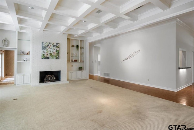 unfurnished living room featuring built in shelves, a brick fireplace, wood-type flooring, and beam ceiling