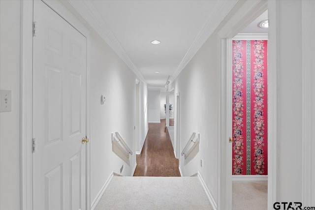 hallway with dark carpet and ornamental molding