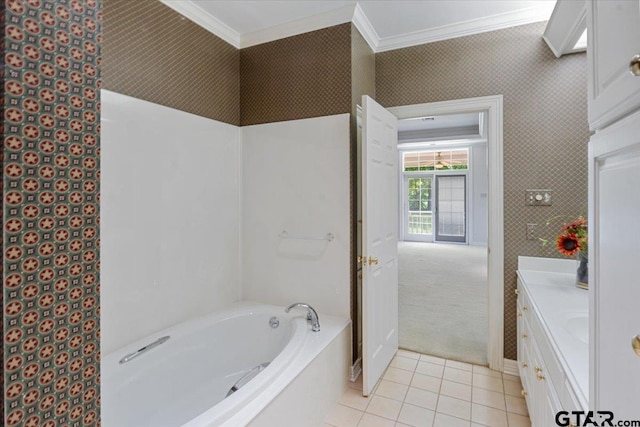 bathroom featuring ornamental molding, a tub, vanity, and tile patterned floors