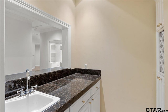 bathroom featuring vanity and crown molding