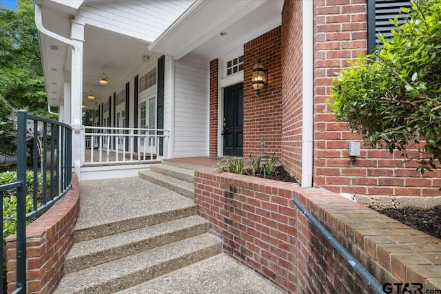 view of exterior entry featuring a porch