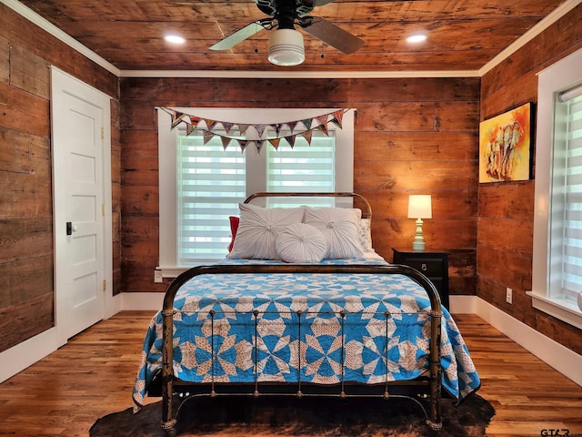 bedroom with wooden walls, wood-type flooring, ceiling fan, and wood ceiling