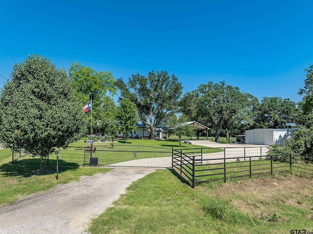 view of property's community featuring an outbuilding and a yard