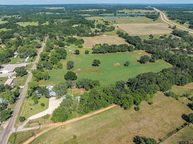 birds eye view of property featuring a water view and a rural view