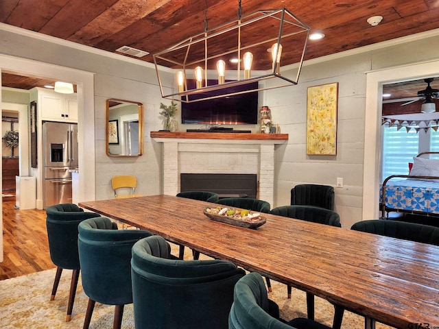 office area with hardwood / wood-style floors, wooden ceiling, a fireplace, and ornamental molding