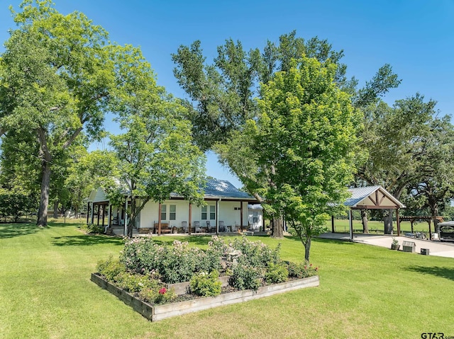 view of yard featuring covered porch and a gazebo