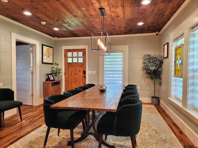 dining space featuring hardwood / wood-style floors, wooden ceiling, and a chandelier