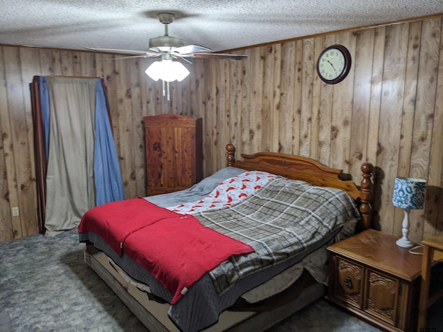 bedroom featuring wooden walls, a textured ceiling, carpet flooring, and ceiling fan