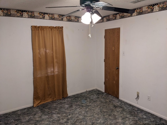 carpeted spare room with ceiling fan and a textured ceiling