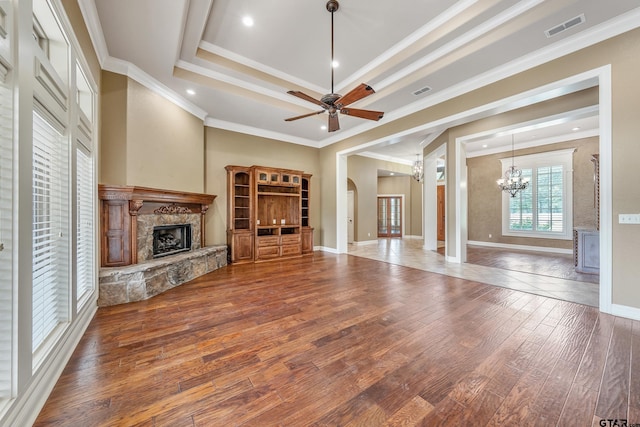 2441 Fm 2685, Gilmer, TX 75644 - unfurnished living room with a fireplace, a chandelier, crown molding, wood finished floors, and ceiling fan