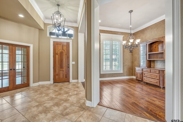 2441 Fm 2685, Gilmer, TX 75644 - entryway featuring a chandelier, plenty of natural light, ornamental molding, and french doors