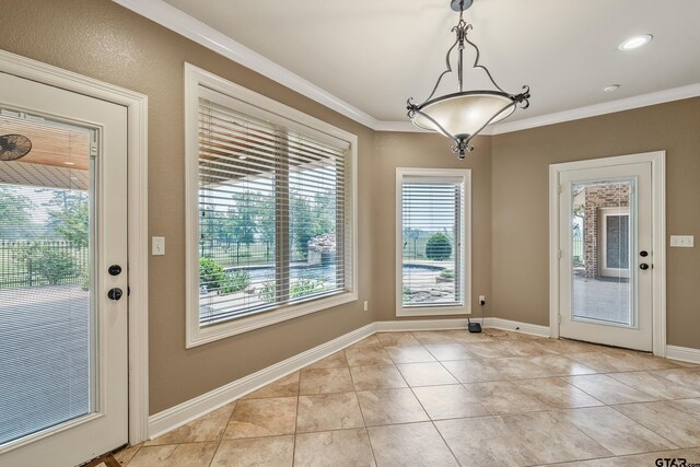2441 Fm 2685, Gilmer, TX 75644 - unfurnished dining area with crown molding, light tile patterned floors, and baseboards