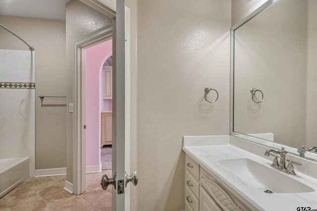 2441 Fm 2685, Gilmer, TX 75644 - bathroom featuring tile patterned flooring, vanity, and bathing tub / shower combination