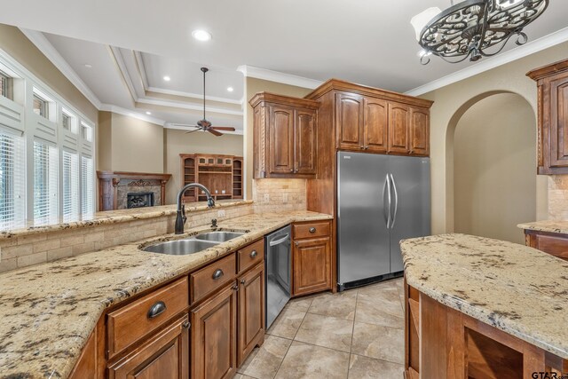 2441 Fm 2685, Gilmer, TX 75644 - kitchen with stainless steel appliances, a sink, a fireplace, tasteful backsplash, and ornamental molding