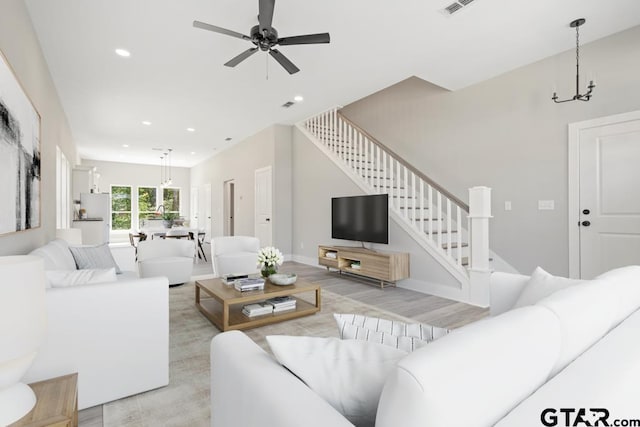 16330 Crossing Cir, Lindale, TX 75771 - living area featuring stairs, a ceiling fan, recessed lighting, a chandelier, and light wood-type flooring