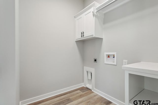 16330 Crossing Cir, Lindale, TX 75771 - laundry room featuring cabinet space, hookup for a washing machine, light wood-style flooring, and electric dryer hookup