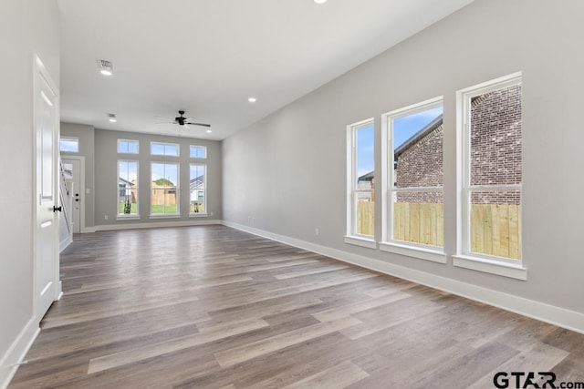 16330 Crossing Cir, Lindale, TX 75771 - unfurnished living room with plenty of natural light, a ceiling fan, wood finished floors, and recessed lighting