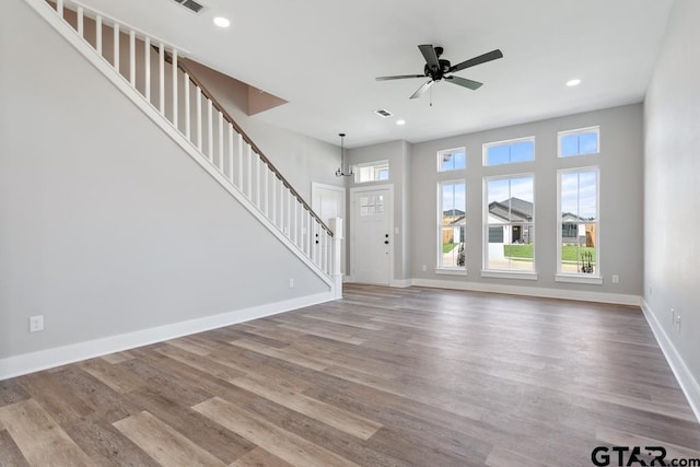 16330 Crossing Cir, Lindale, TX 75771 - unfurnished living room featuring stairway, wood finished floors, a ceiling fan, and recessed lighting