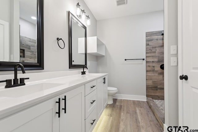 16330 Crossing Cir, Lindale, TX 75771 - full bath featuring double vanity, wood finished floors, and a tile shower