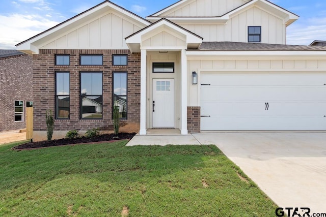 16330 Crossing Cir, Lindale, TX 75771 - modern farmhouse with board and batten siding, a front yard, driveway, an attached garage, and brick siding